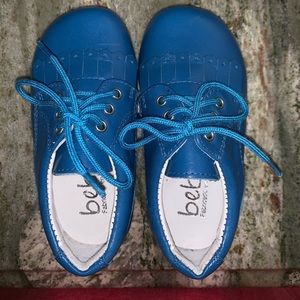 Bright blue classic wingtip shoe.